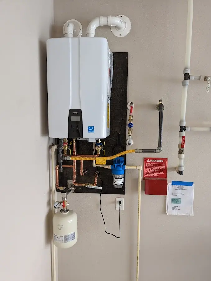 Professional plumber installing copper piping in a Edenton home